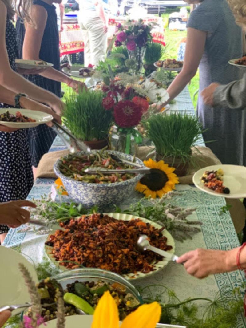 people at a buffet table serving themselves food